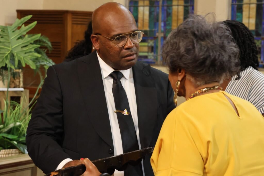 District 1 Councilman Cory Penn speaking with an individual during the community meeting .
