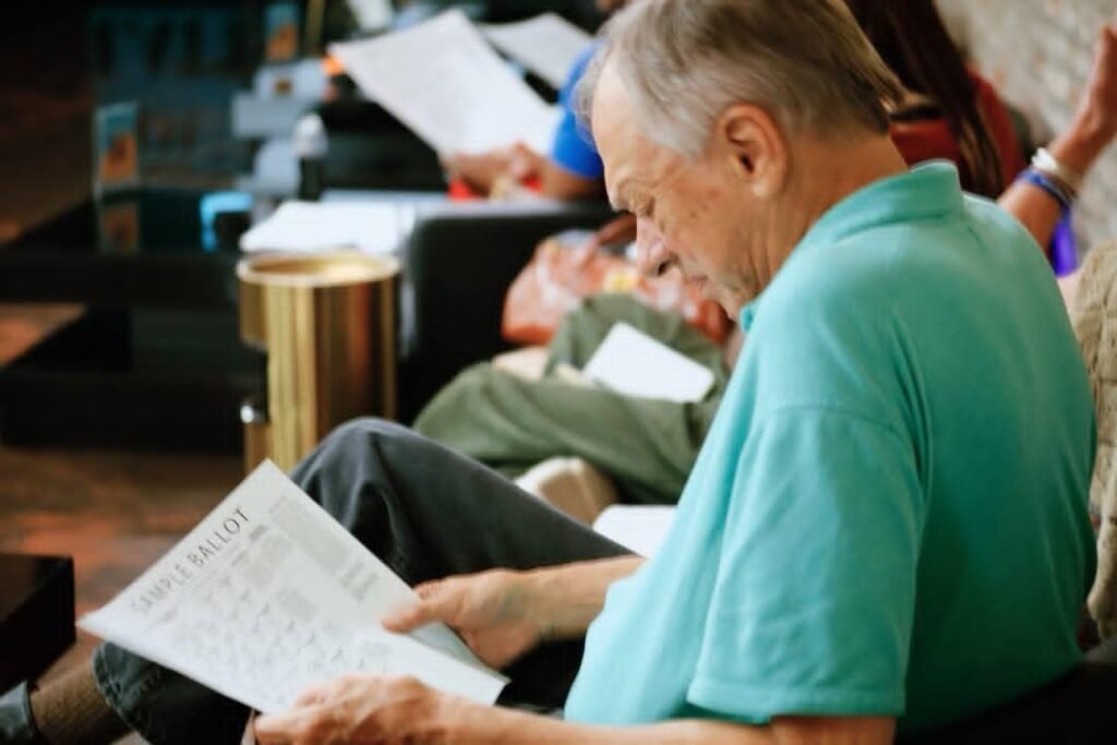 An attendee reviewing a sample ballot at the Great Day Latte civics event