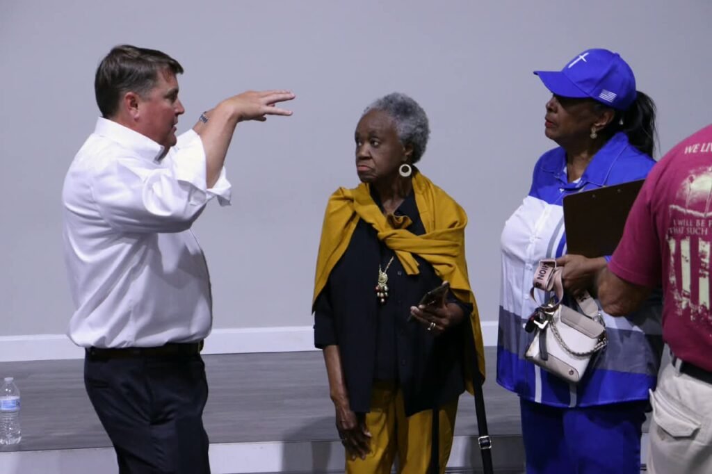 Councilman Ben Reynolds talking with local residents after the community meeting.