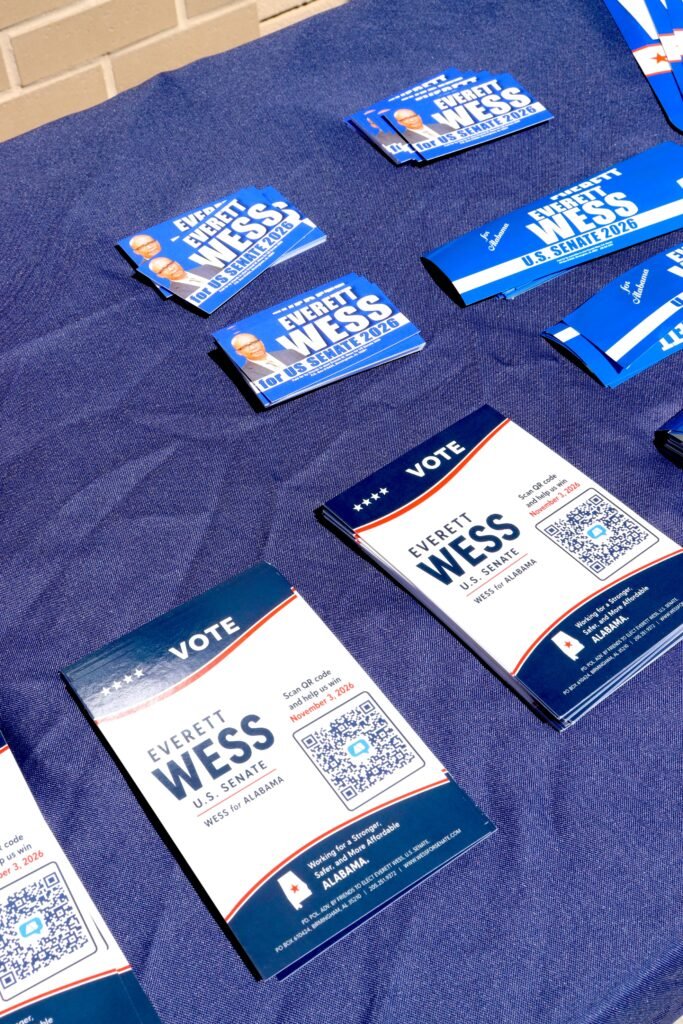 Official Everett W. Wess U.S. Senate campaign flyers and voting information cards on a blue tablecloth.