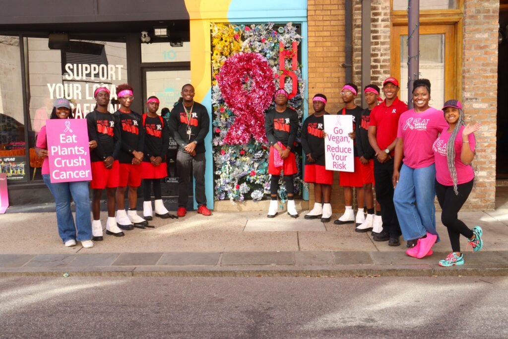 The B.C.R. Drum Line lines up outside Great Day Latte with event participants, including organizer India Washington and owner Kimberly Knight on the far right.
