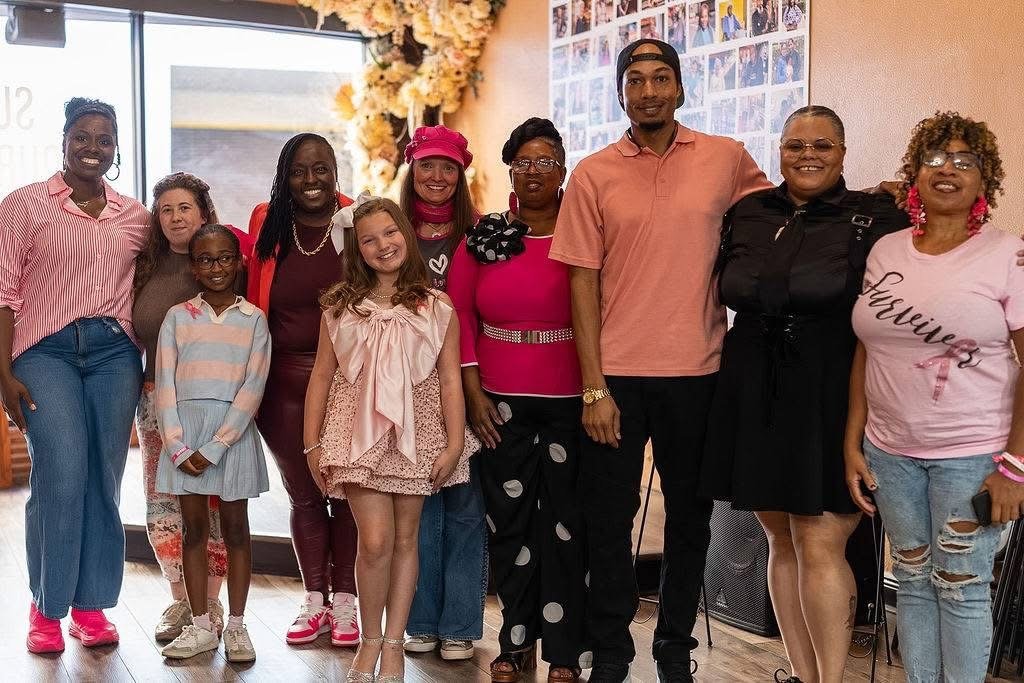 Founder India Washington and event attendees gather inside Great Day Latte for the inaugural community wellness experience.