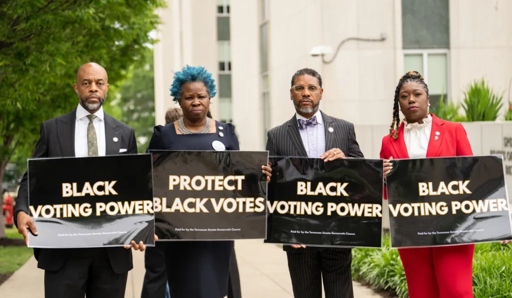 Activists holding Black Voting Power and Protect Black Votes signs.